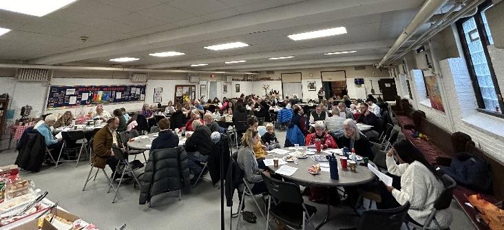 Picture of members meeting for Breakfast Church around tables
